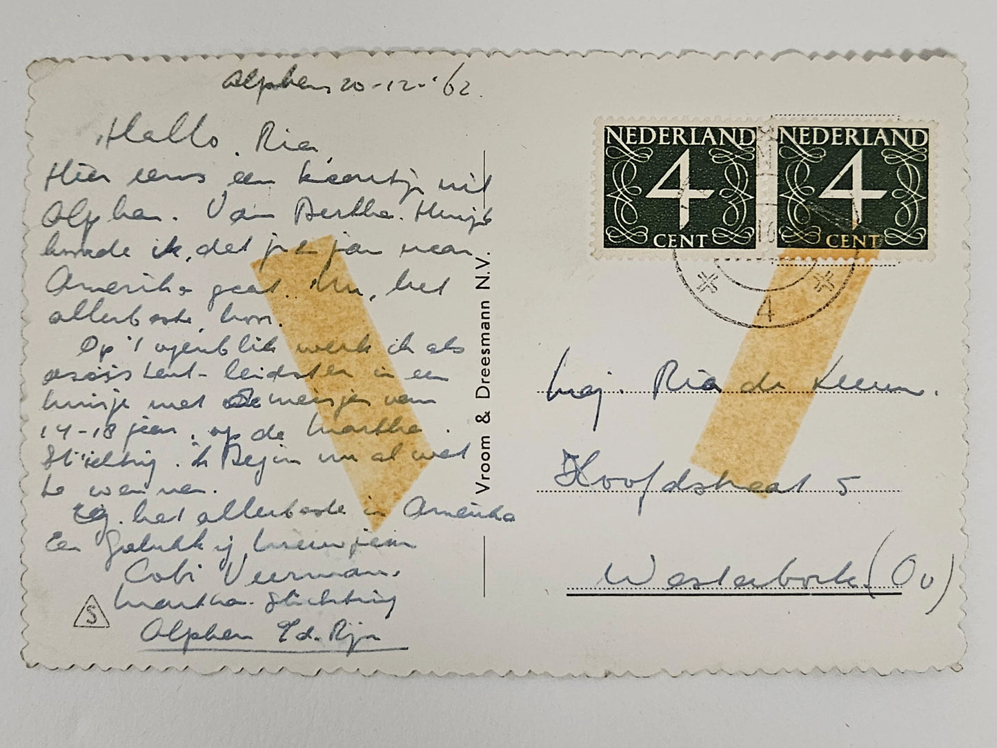 Vintage postcard with handwritten text and postage stamps, featuring a yellow stain.