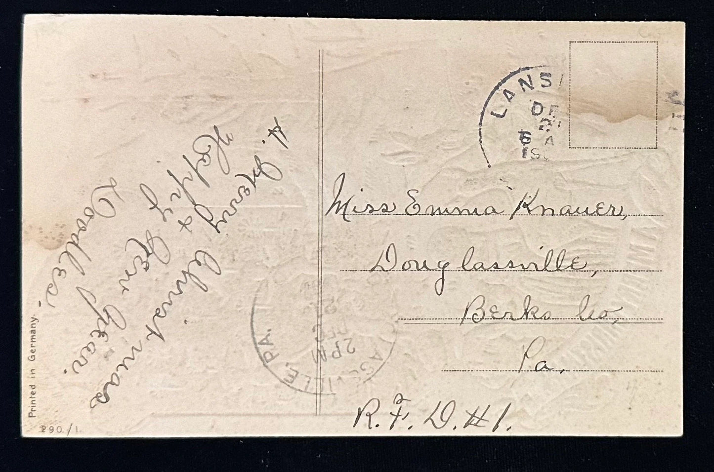 Vintage postcard with handwritten text and a stamp on a black background