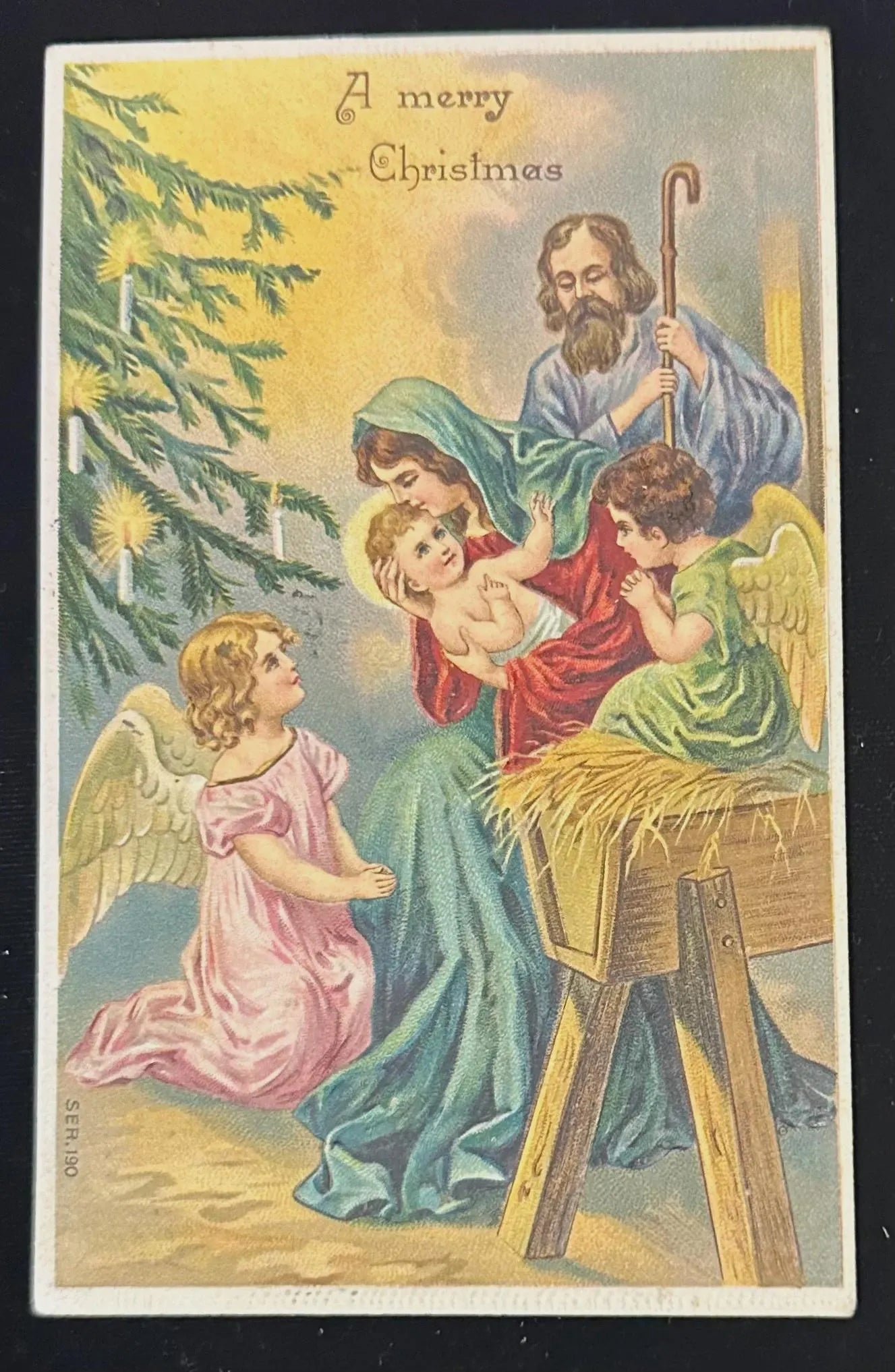 Vintage Christmas card with Holy Family and angels, featuring a shepherd and two angels.