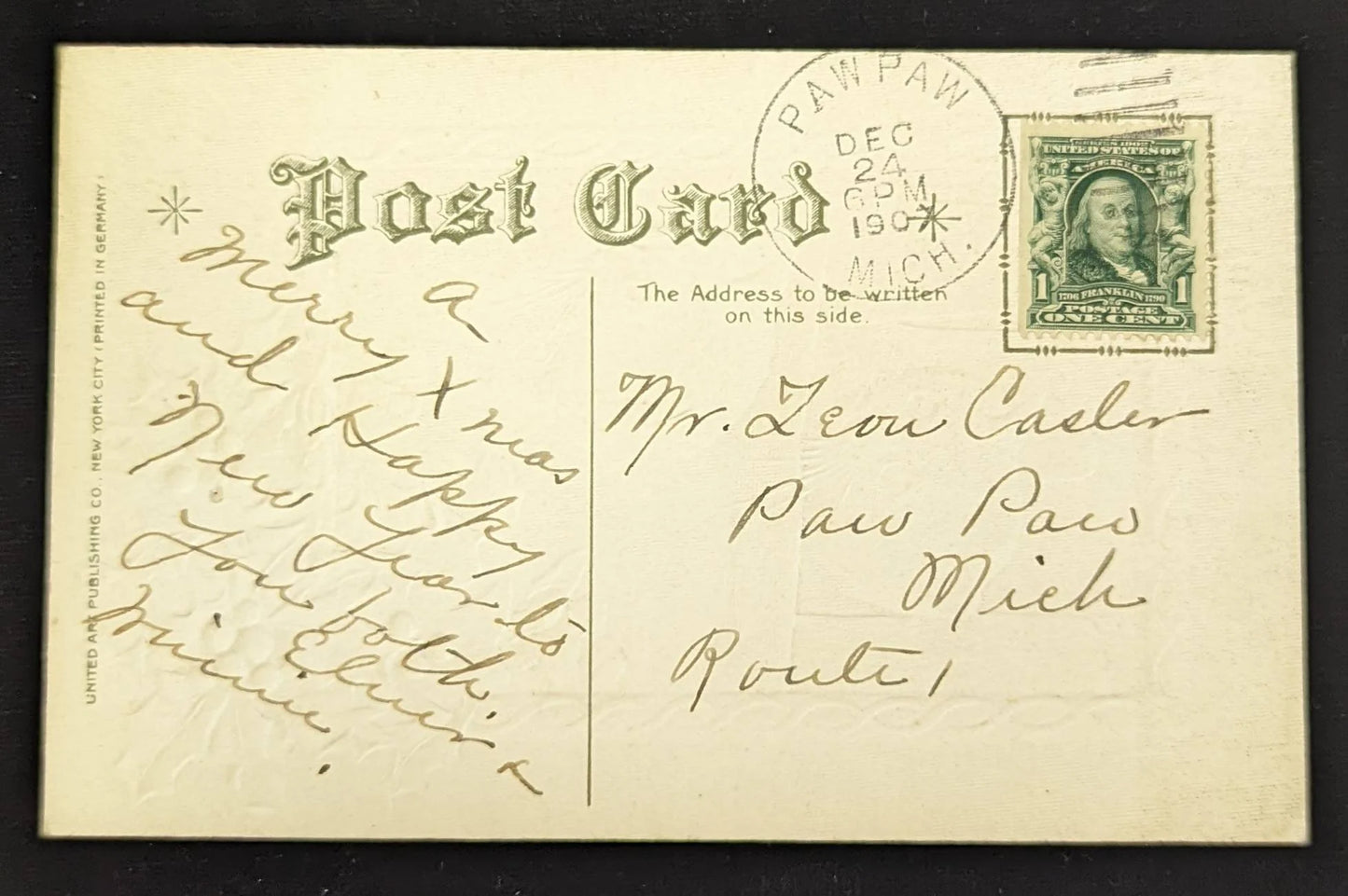 Vintage postcard with text and a stamp, featuring a decorative border and stationery details.