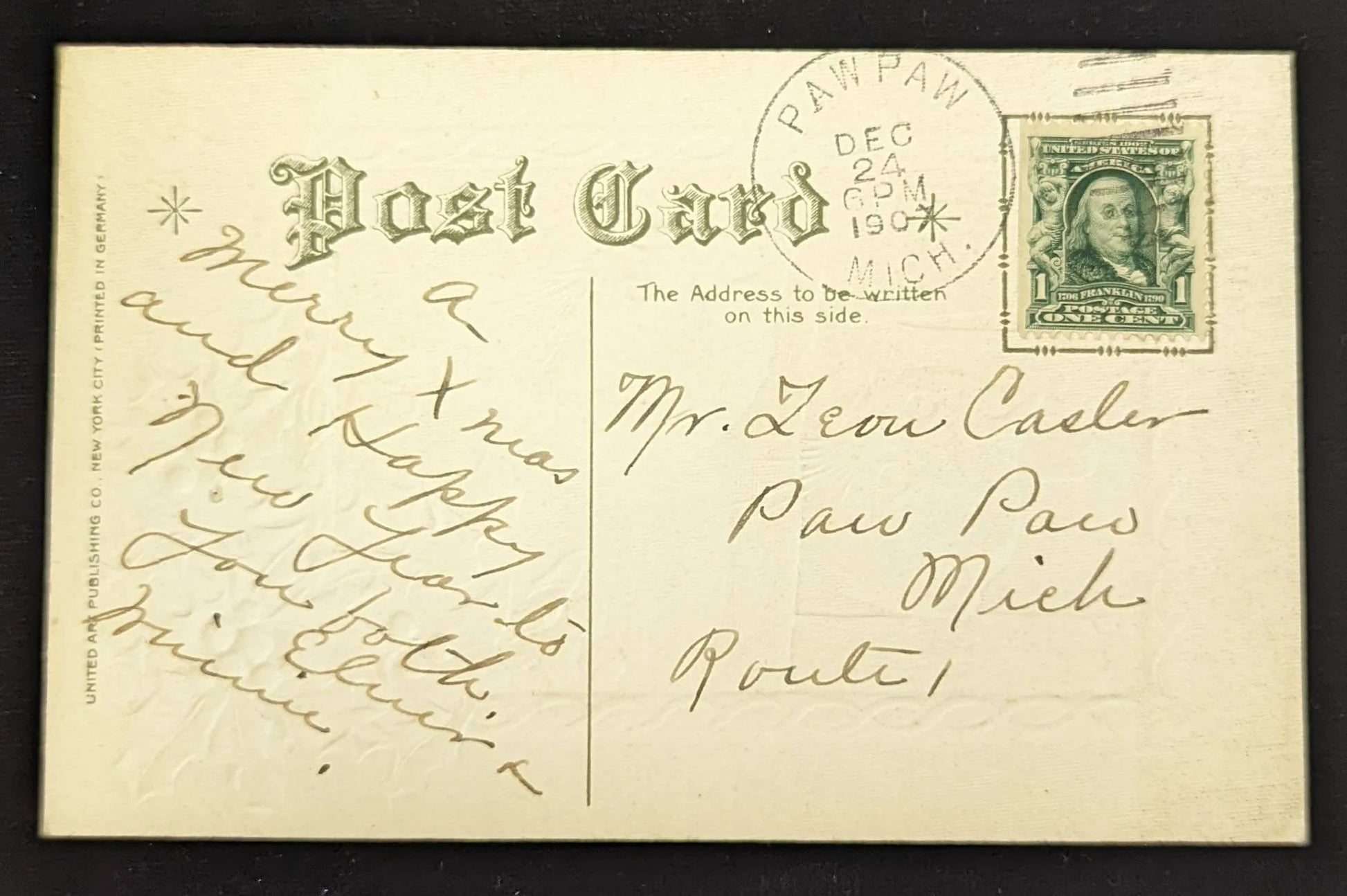 Vintage postcard with text and a stamp, featuring a decorative border and stationery details.