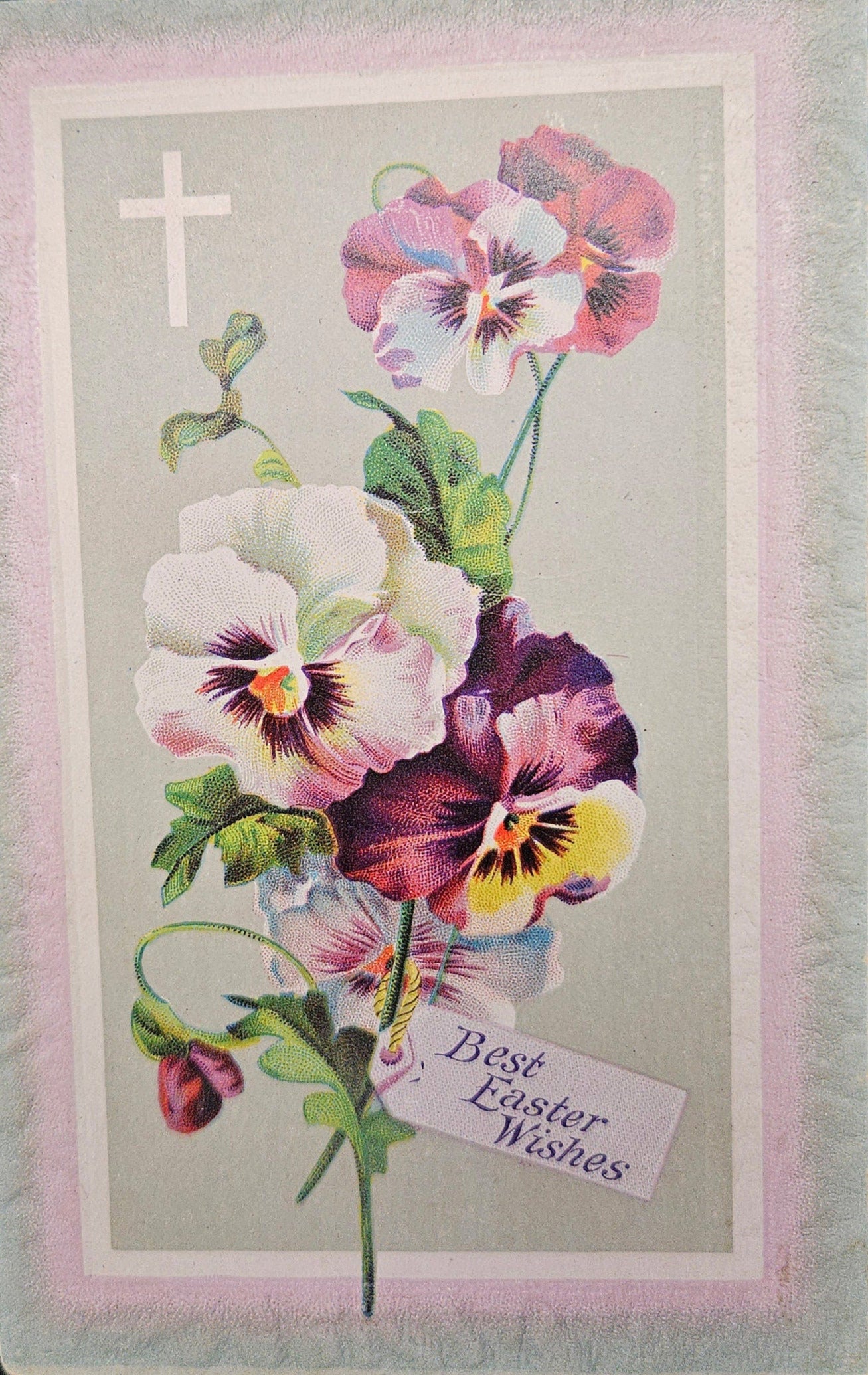A vintage Easter postcard featuring a bouquet of pansies with a religious cross in the top left corner and a 'Best Easter Wishes' tag.