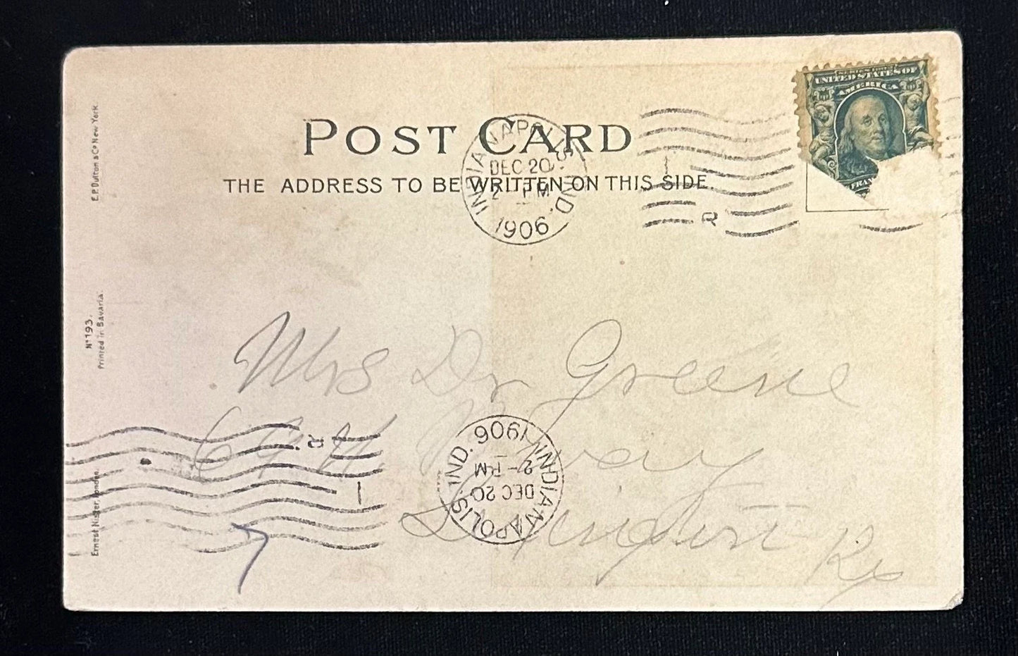 Vintage postcard with stamps and cursive writing on a black background