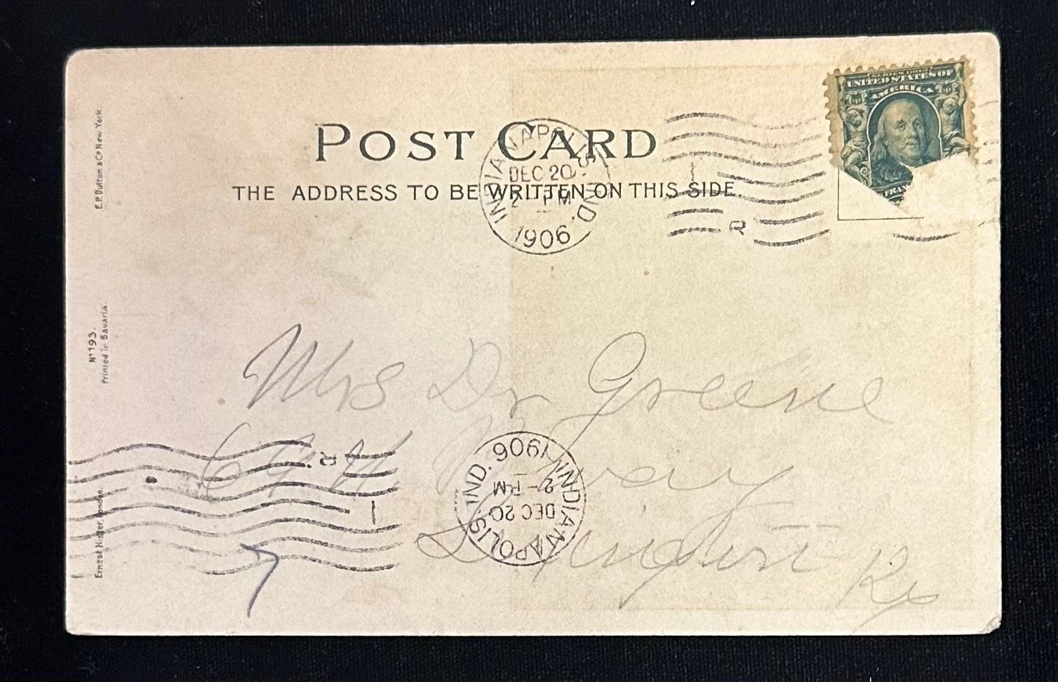 Vintage postcard with stamps and cursive writing on a black background