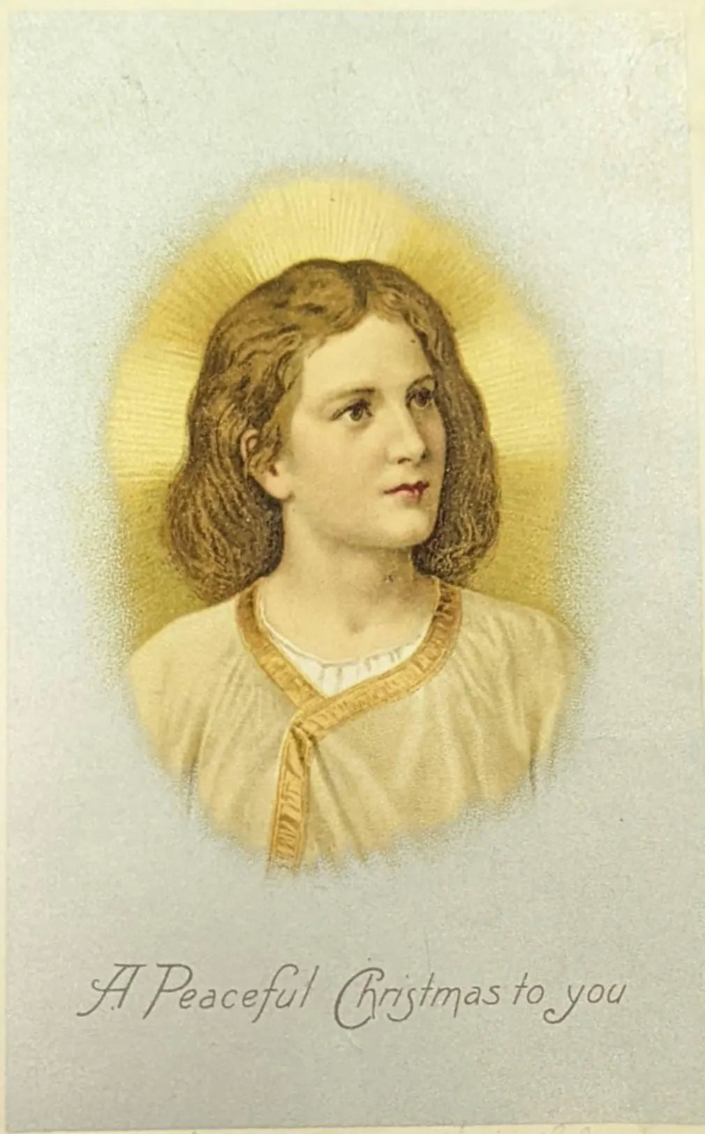 Vintage-style Christmas card with a young girl's portrait and 'A Peaceful Christmas to you' text.