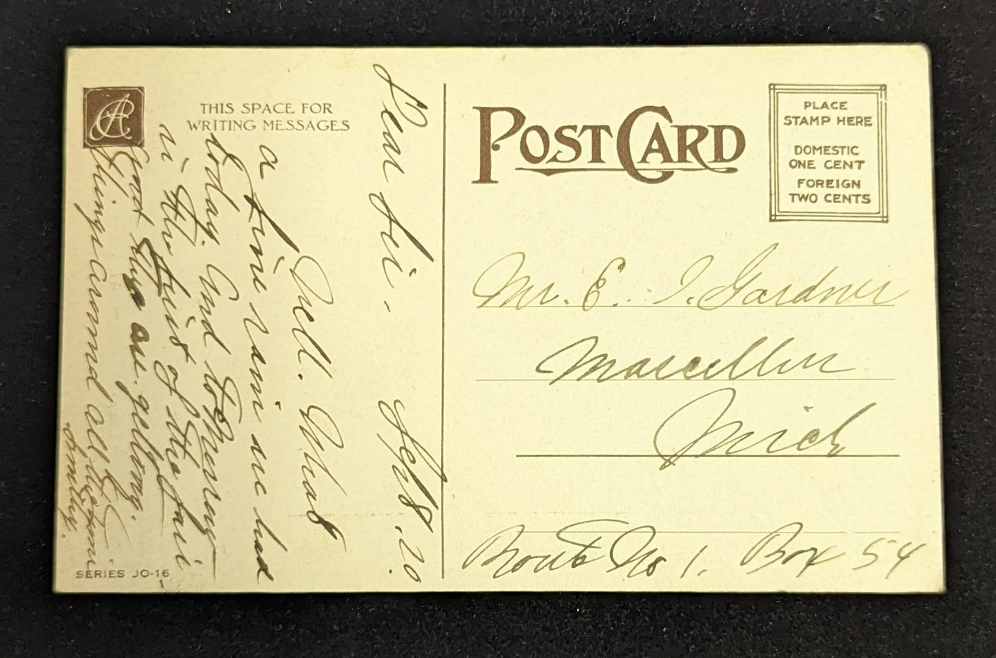 Vintage postcard with handwritten text on a dark background