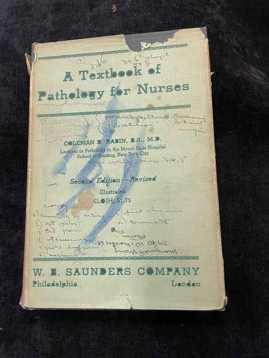 Vintage book titled 'A Textbook of Pathology for Nurses' by W. E. Saunders Company on a dark background