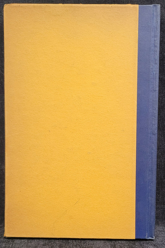 Yellow book with a blue spine on a dark surface