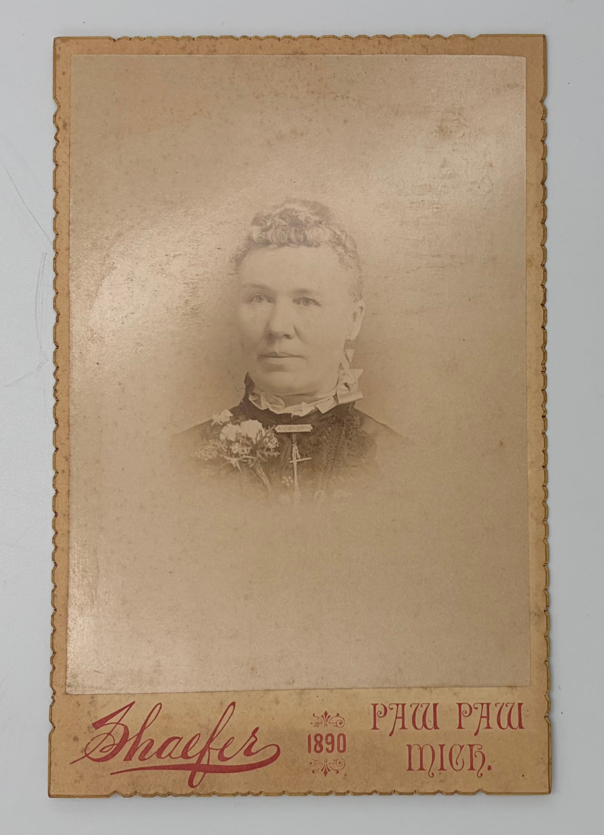 An antique 1890 cabinet portrait photograph card featuring a sepia-toned portrait of a woman, with the photographer name 'Shaefer' and location 'Paw, Paw, Mich.' printed at the bottom.
