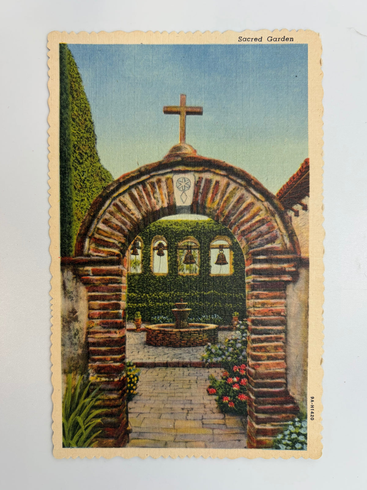 This linen postcard was printed in 1939 with a hand-colored view of the entrance to the San Juan Capistrano gardens. 