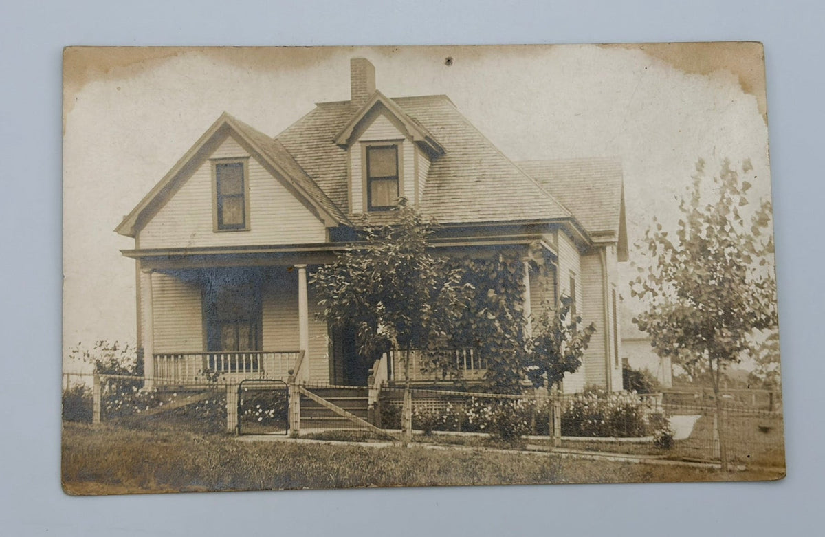 A vintage sepia-toned photograph print of a house