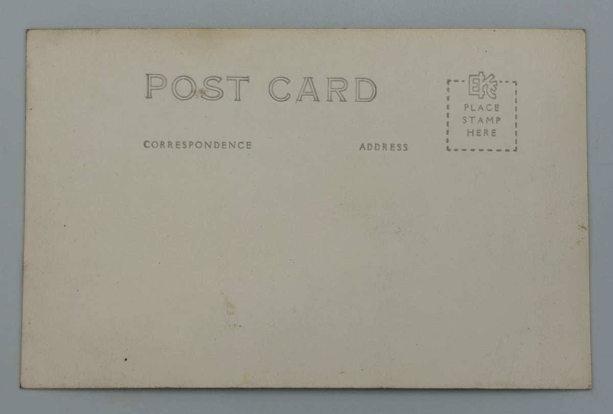 An aged cream-colored postcard with 'POST CARD' printed on the back