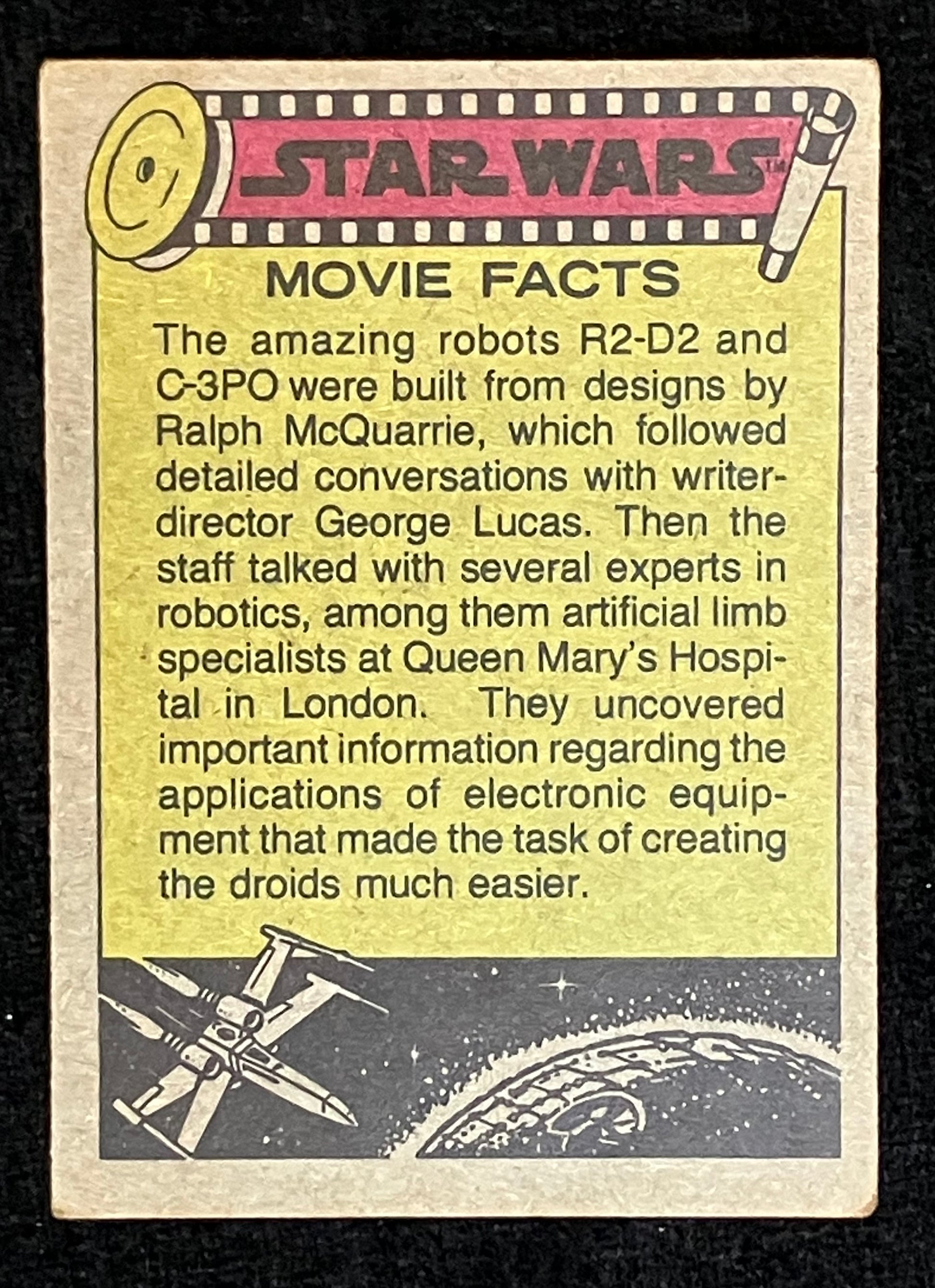 A vintage Star Wars movie facts trading card with text about robots R-2D-2 and C-3PO, featuring a yellow background, black border, and Star Wars logo at the top.