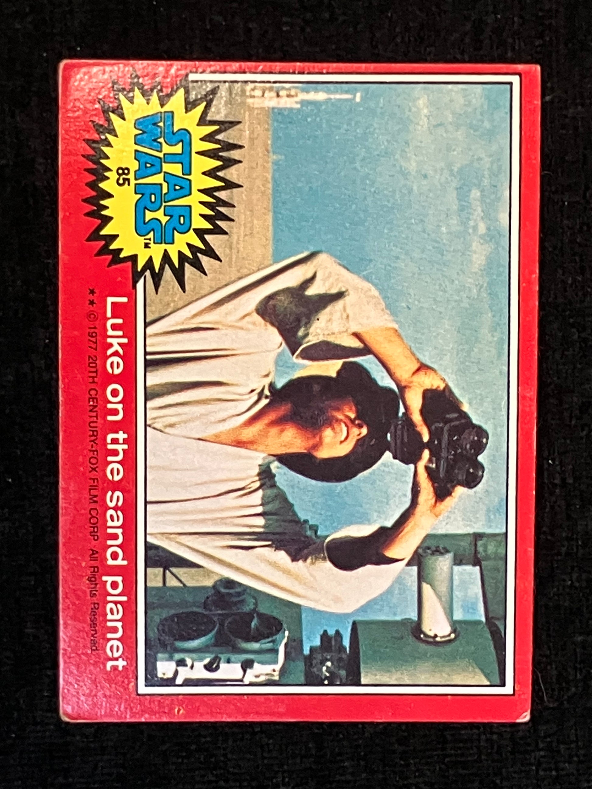 Vintage Star Wars trading card featuring Luke Skywalker on sand planet Tatooine with a red border.