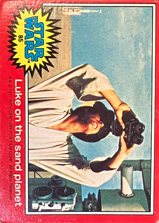 Vintage Star Wars trading card featuring Luke Skywalker on sand planet Tatooine with a red border.