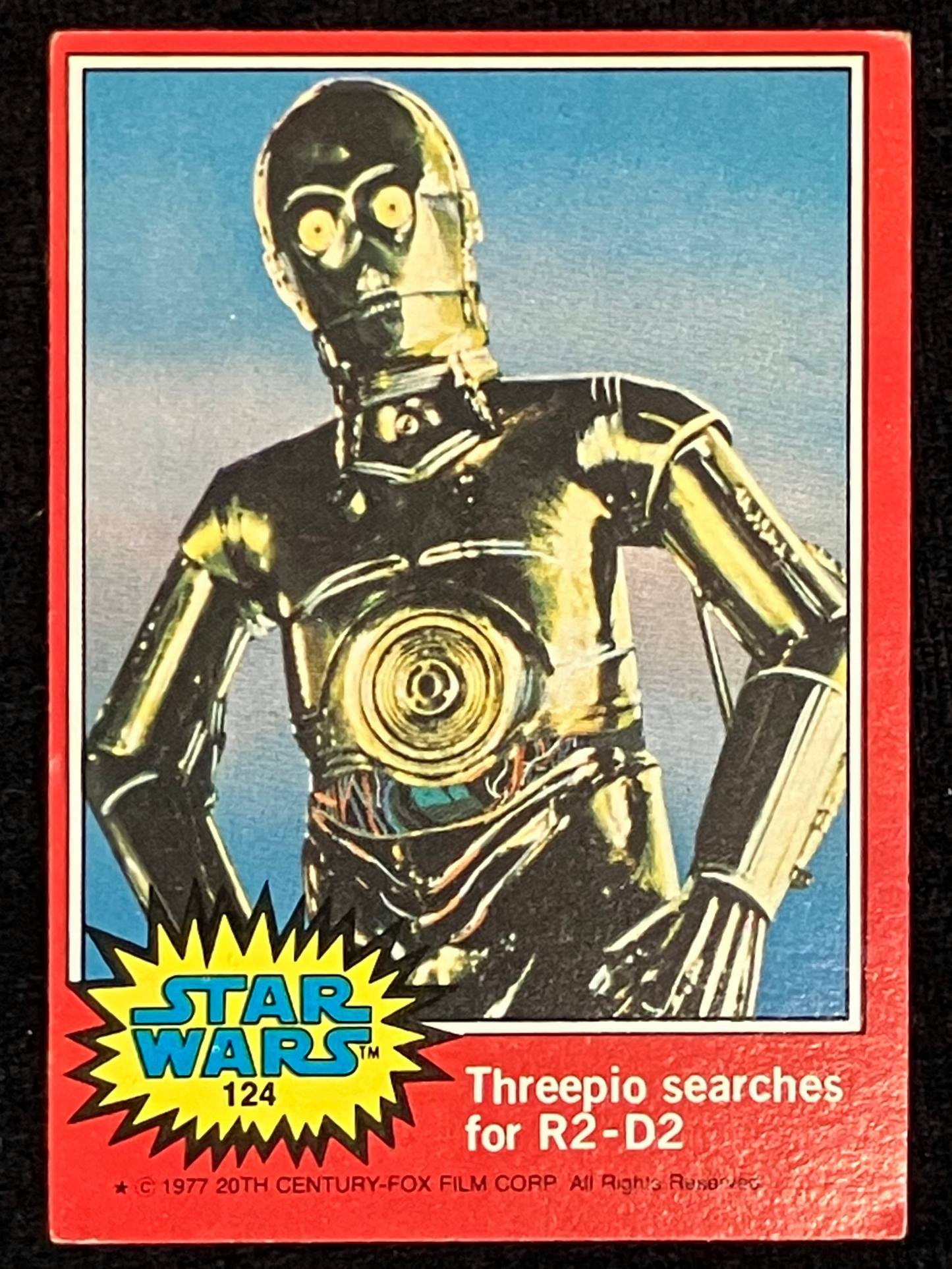 A vintage Star Wars trading card featuring C-3PO, with a red border, blue sky background, and a yellow Star Wars logo in the lower left corner.