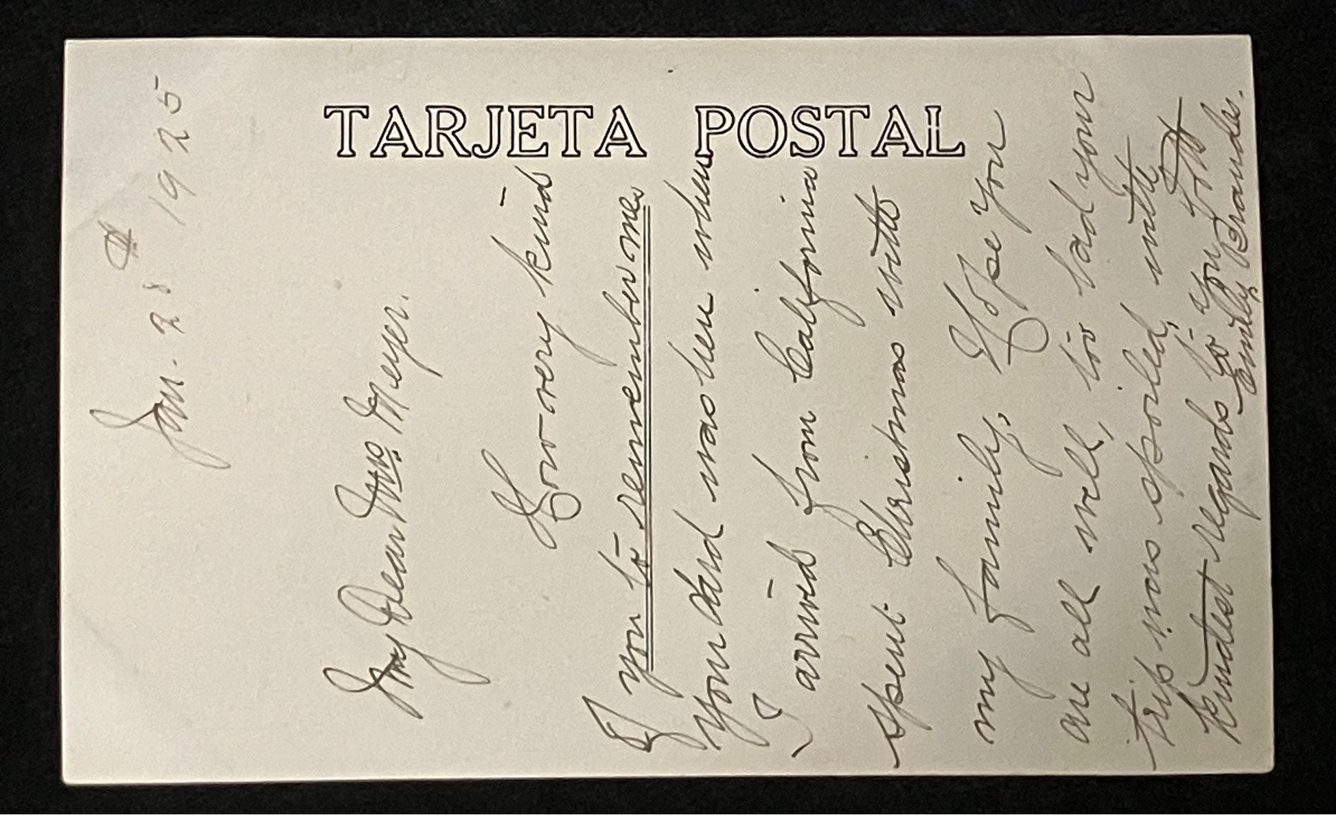 A vintage handwritten postcard with 'TARJETA POSTAL' printed vertically on the left side, photographed against a dark background.