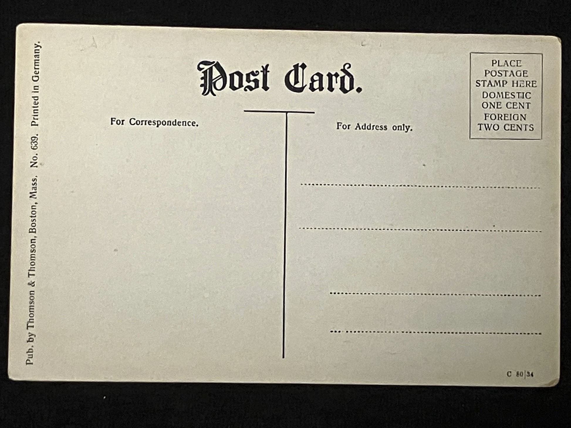 Back of a vintage postcard with text and design elements on a black background