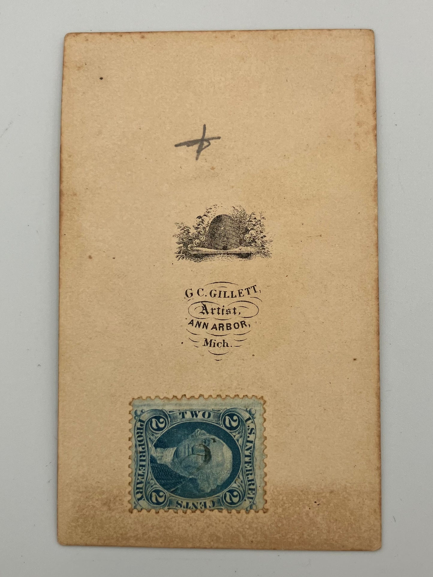 A vintage aged beige paper card featuring a blue two-cent stamp at the bottom left and printed text