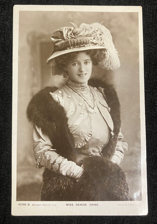 Vintage photograph of Denise Orne in an ornate hat and coat with feathered trim.