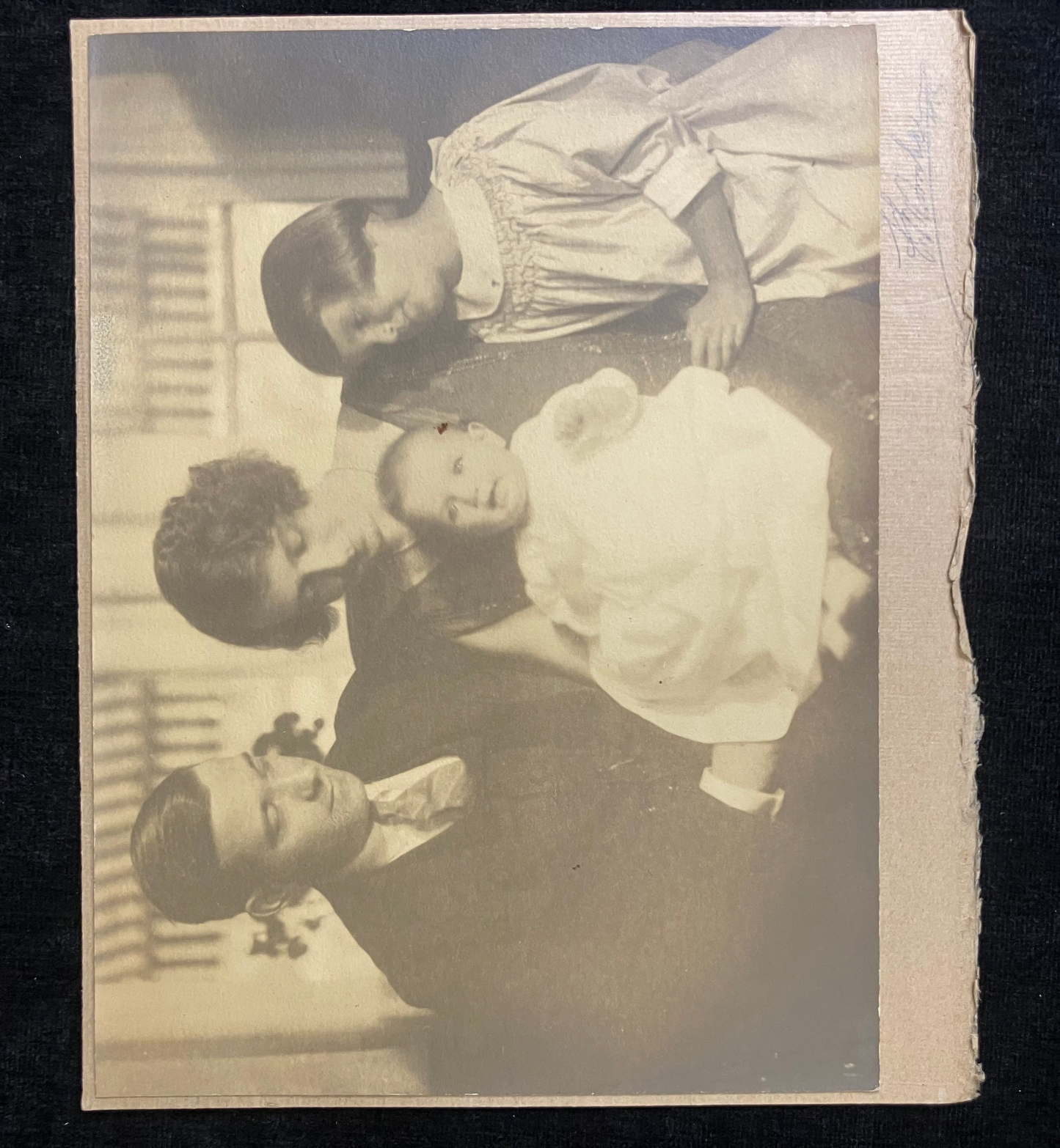 Vintage sepia-toned photograph of a family with children, likely from the early 20th century.
