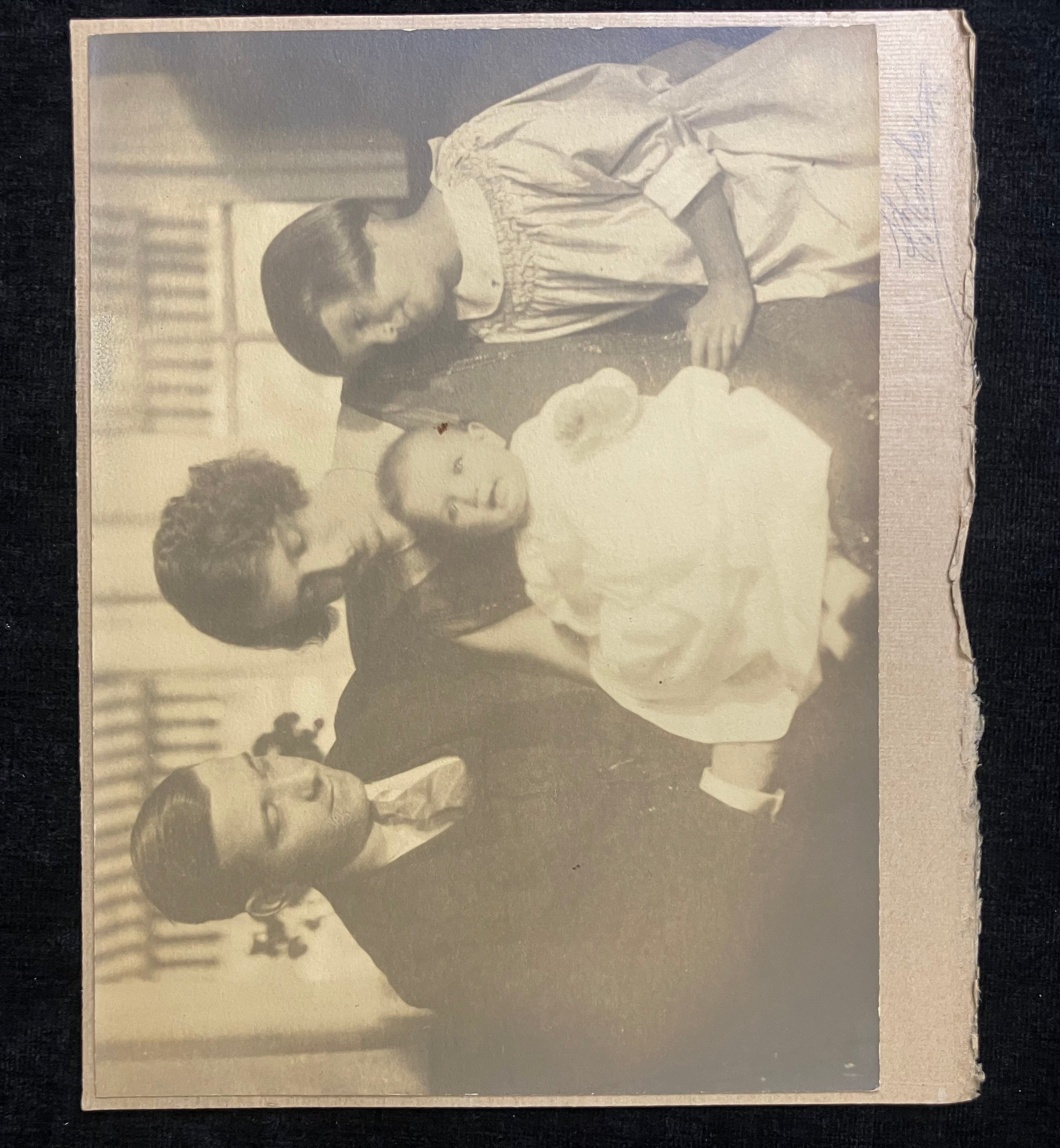 Vintage sepia-toned photograph of a family with children, likely from the early 20th century.