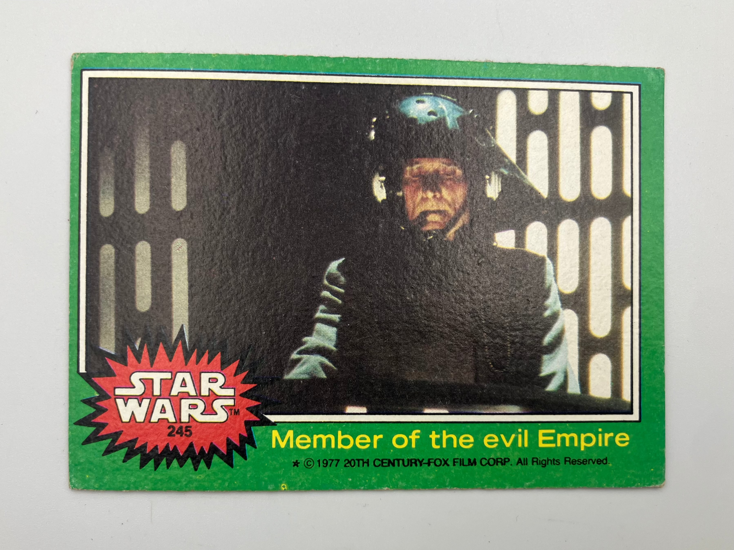 A vintage 1971 Star Wars trading card, number 246, titled 'Member of the evil Empire'. The card features a green border, a red starburst logo, and a black-and-white photo of Darth Vader wearing a helmet.