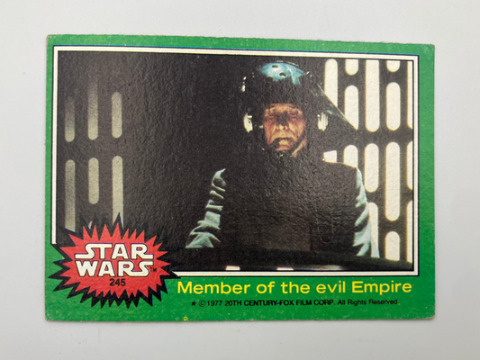 A vintage 1971 Star Wars trading card, number 246, titled 'Member of the evil Empire'. The card features a green border, a red starburst logo, and a black-and-white photo of Darth Vader wearing a helmet.