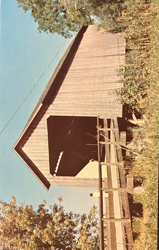 Wooden covered bridge with trees on either side