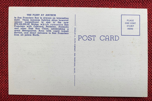 This linen postcard features a hand tinted photograph of United States Battleships at anchor in the 