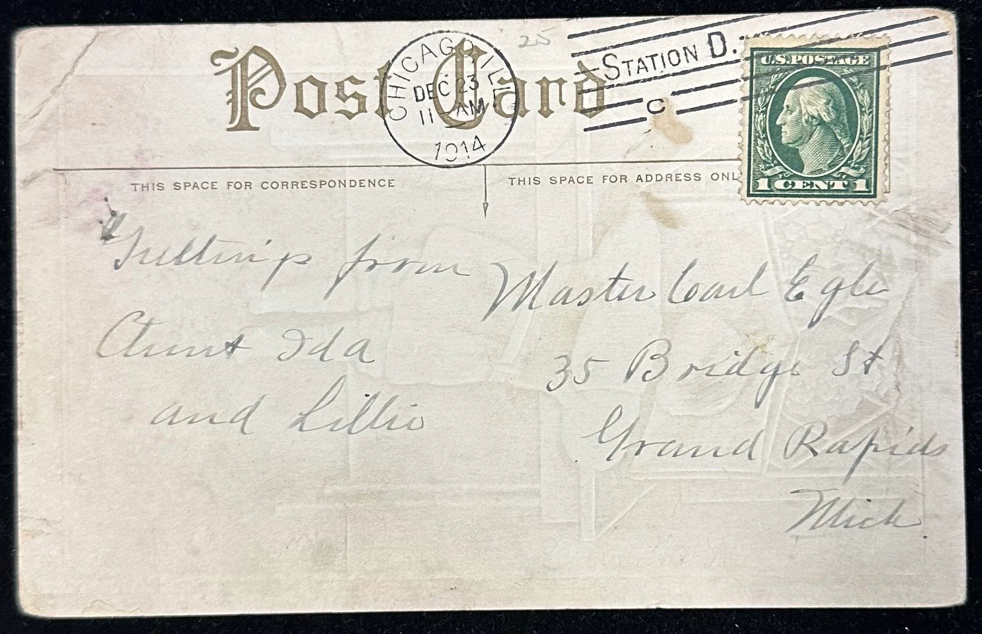Vintage postcard with a stamp and handwritten text, featuring 'Chicago Post Card Station D' on a black background.