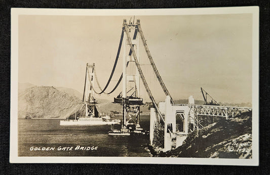 RPPC - Golden Gate Bridge Under Construction - 1935 Postcard Black/ White Photo - Bridge Construction Photo - Naval Ship Passing under Bridge