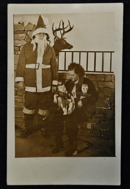 RPPC - Santa Claus with Mother and Baby - Taxidermy Deer in Background - Sepia Toned Christmas Photo Postcard from 1930s - Fun Photo Backdrop