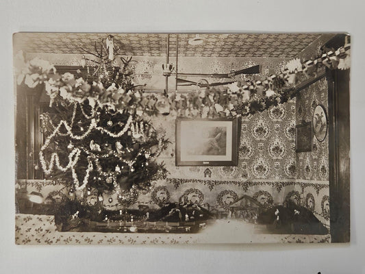 RPPC - 1910 Christmas Tree Decorations - Hunter's Christmas Decor - Tinsel Garlands, Nativity Scene, and Mounted Guns - Hunter Heaven in 1910