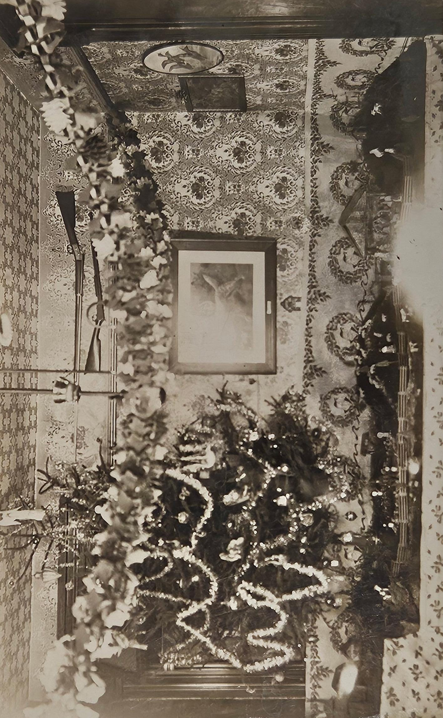 RPPC - 1910 Christmas Tree Decorations - Hunter's Christmas Decor - Tinsel Garlands, Nativity Scene, and Mounted Guns - Hunter Heaven in 1910