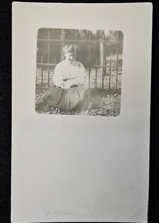 RPPC - Portrait of Smiling Teenage Girl - In Victorian Clothing by Iron Fence - Bashful Teen Posing in Bright Sunshine Real Photo Postcard