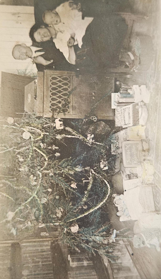 RPPC - Family by Christmas Tree - 1930 Phonograph in Background - Gifts Under Tree for Mother, Father, and Baby - Blown Glass Ornaments on Tree