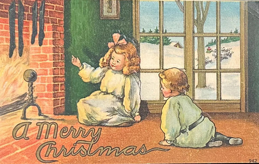 Children by the Fireplace with Stockings - A Merry Christmas - Vintage Postcard