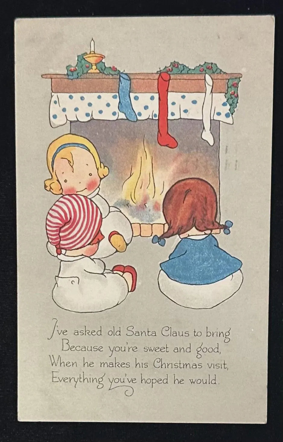 Vintage Christmas postcard with two children by a fireplace and a poem.