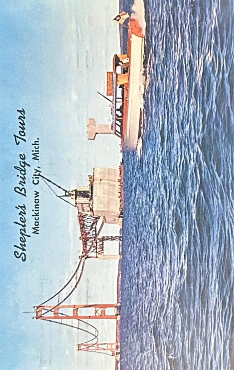 Vintage postcard of construction of the Mackinaw Bridge with Sheplers Bridge Tours text.