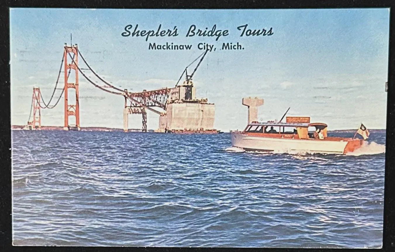 Vintage postcard of construction of the Mackinaw Bridge with Sheplers Bridge Tours text.