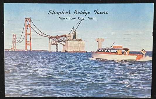 Vintage postcard of construction of the Mackinaw Bridge with Sheplers Bridge Tours text.