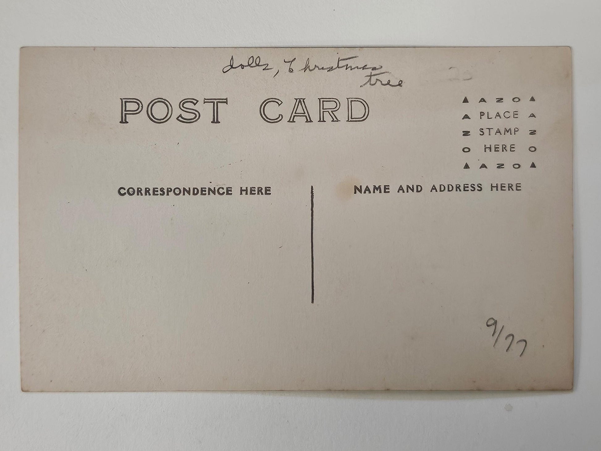 The dolls, the tinsel tree decorations and little girls dresses in this RPPC are like those found in